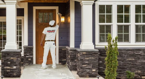 painter applying fresh coat of paint to home exterior during remodeling project by Tolar, Texas builder